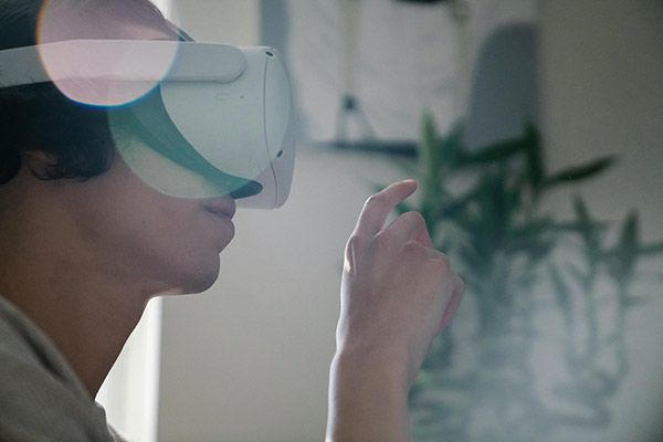 A man wearing Virtual Reality goggles