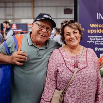 Older couple smiling while attending an event