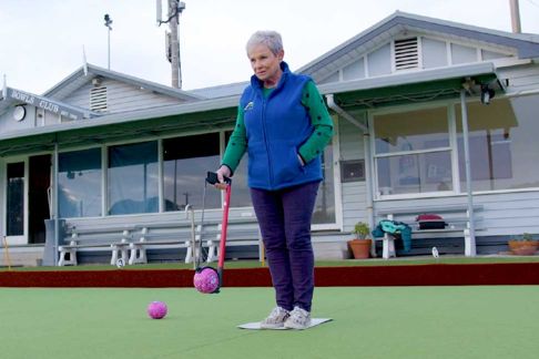 Older lady using a bowling arm
