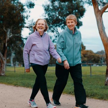 Two older women walking in a park