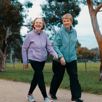 Two older women walking in a park