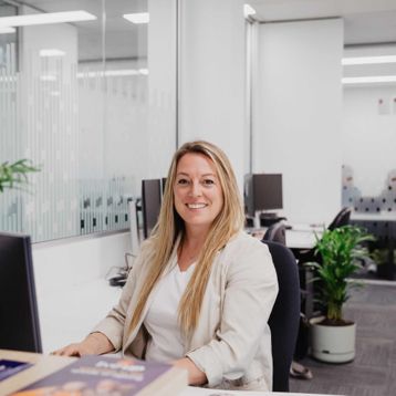Woman sitting at a desk in a modern office