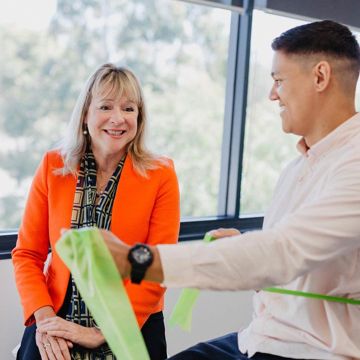 Hilary O'Connell overseeing resistance band use by a client