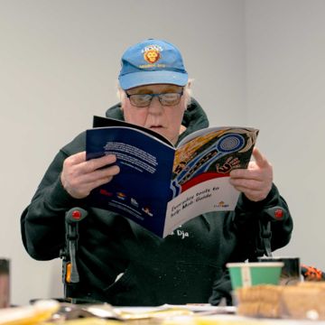 Older man reading a healthy ageing resource