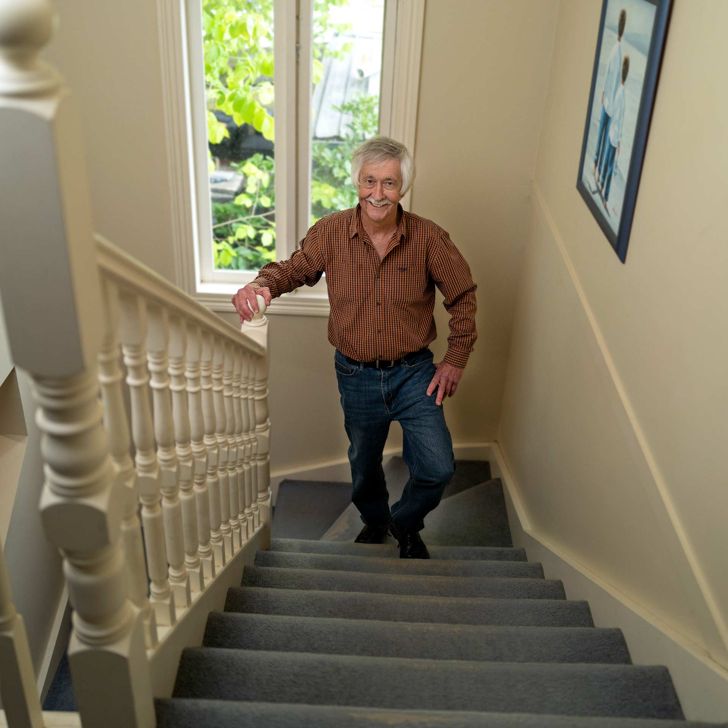 older man climbing stairs