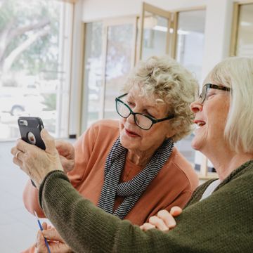 Two older women using a smart phone