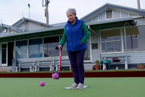 Older lady using a bowling arm