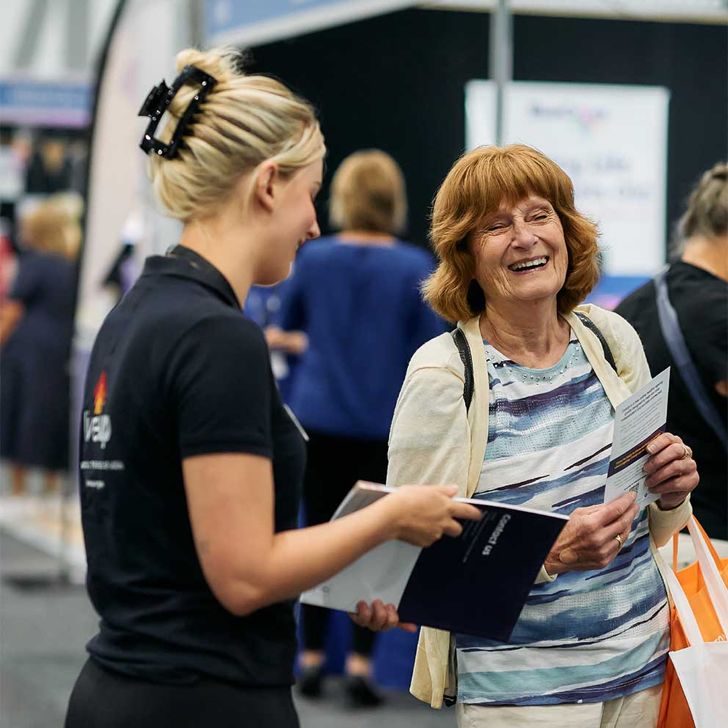 iLA staff member interacting with an older person at an event