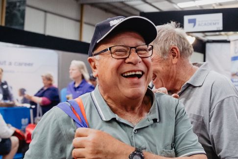 Older man wearing a hat attending an aged care event