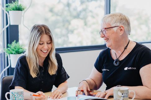 Two iLA staff members working at a desk together