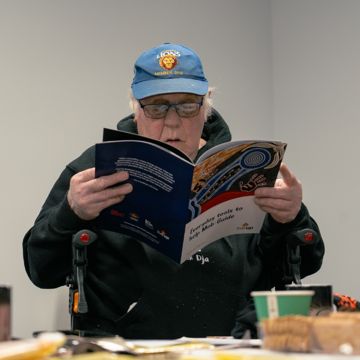 Older man reading a healthy ageing resource