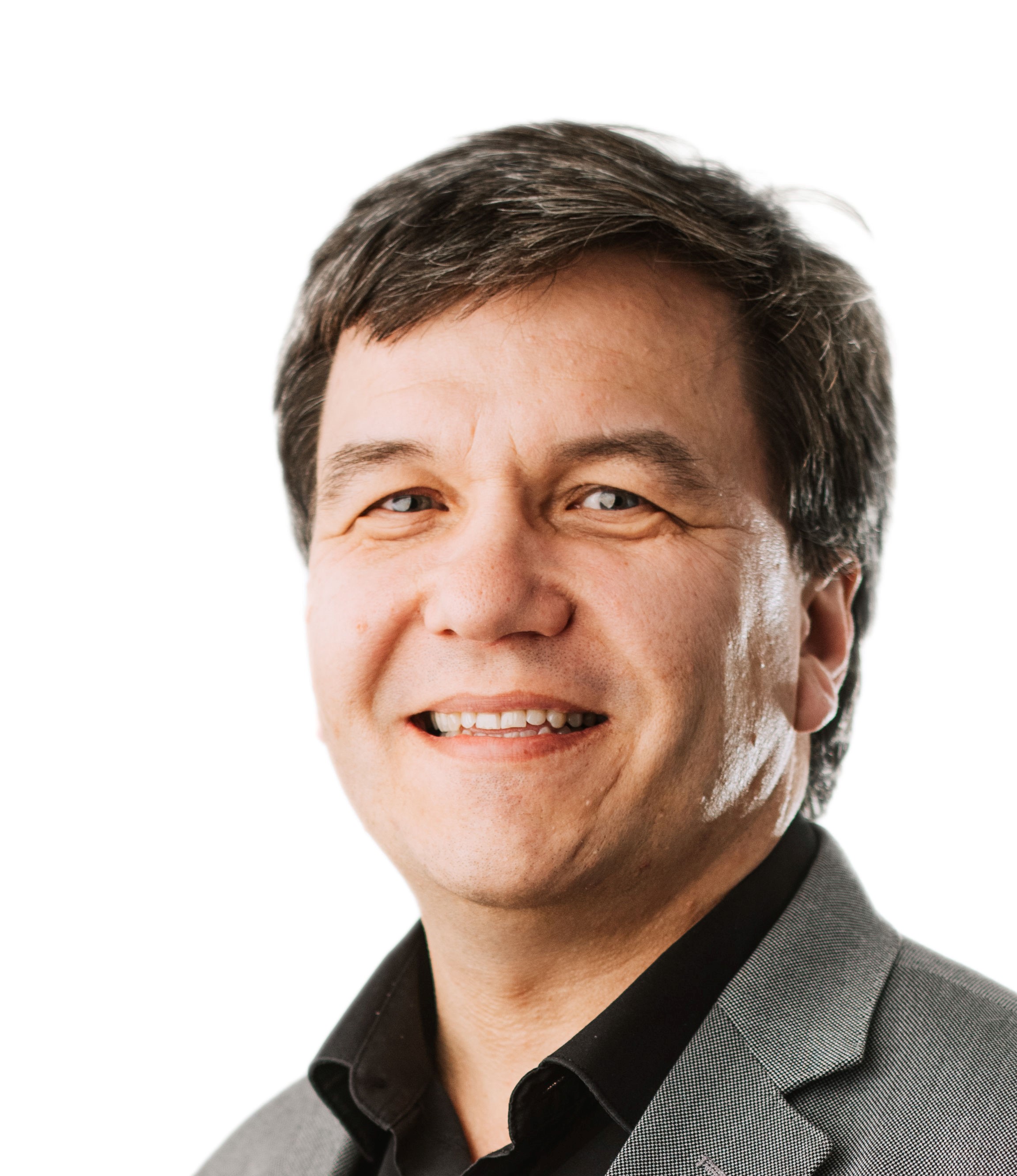 Ian Crop Smiling professional man with short dark hair, wearing black shirt and grey blazer