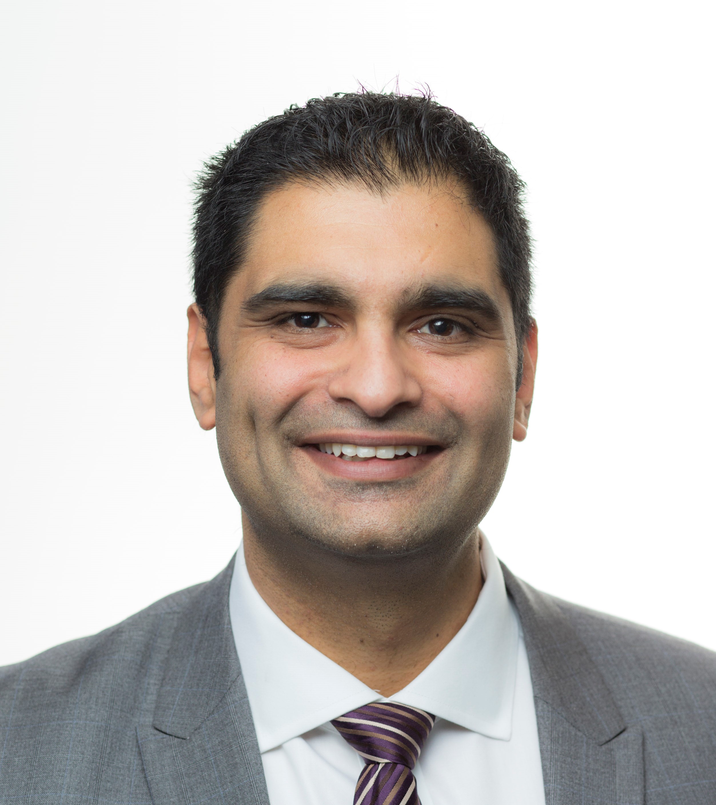 Kunal Crop Smiling professional man with short dark hair