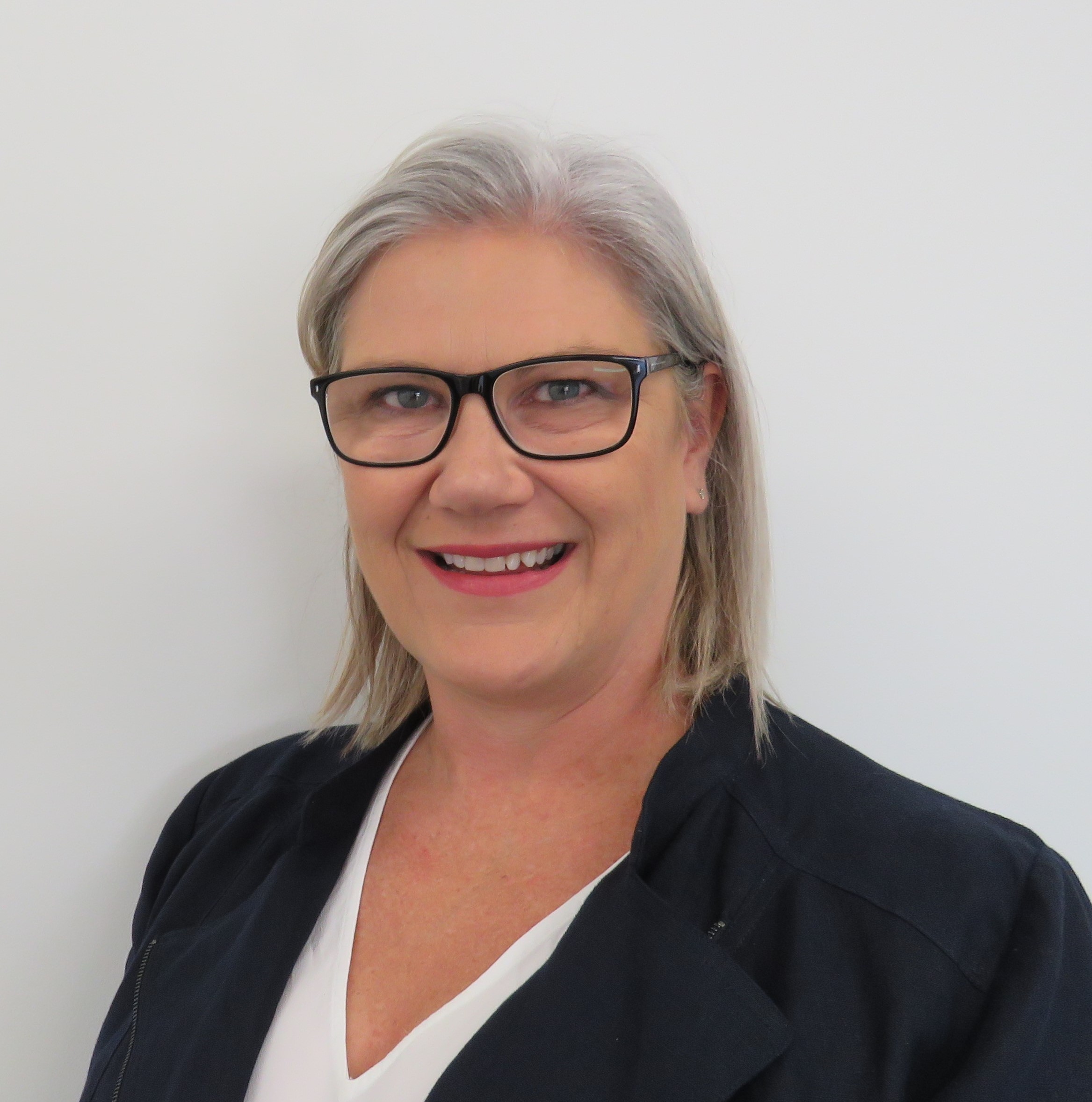 Andrea Morris Professional woman, with grey bob, smiling