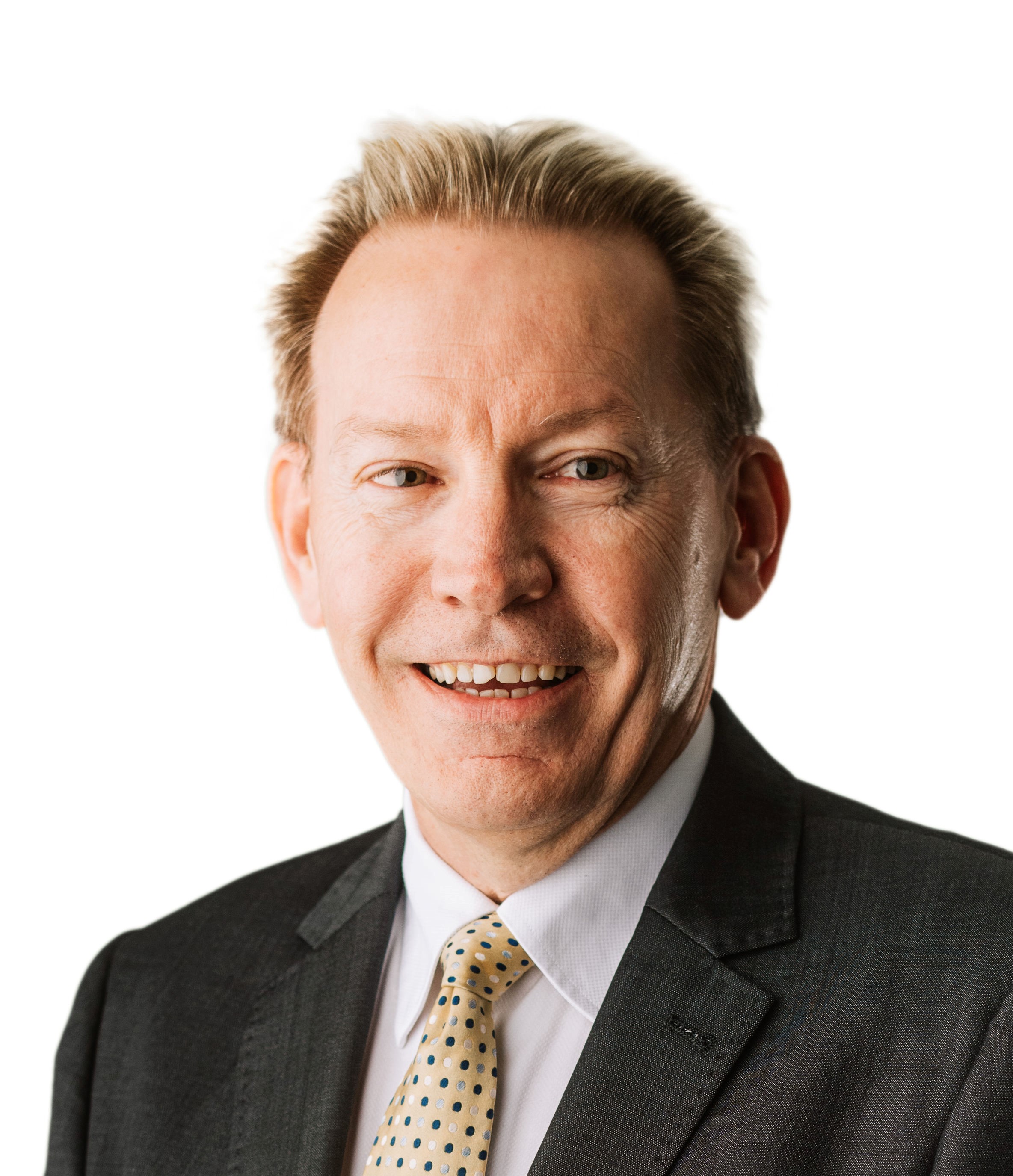Steve Glew professional man, with short blond hair, wearing a suit, smiling
