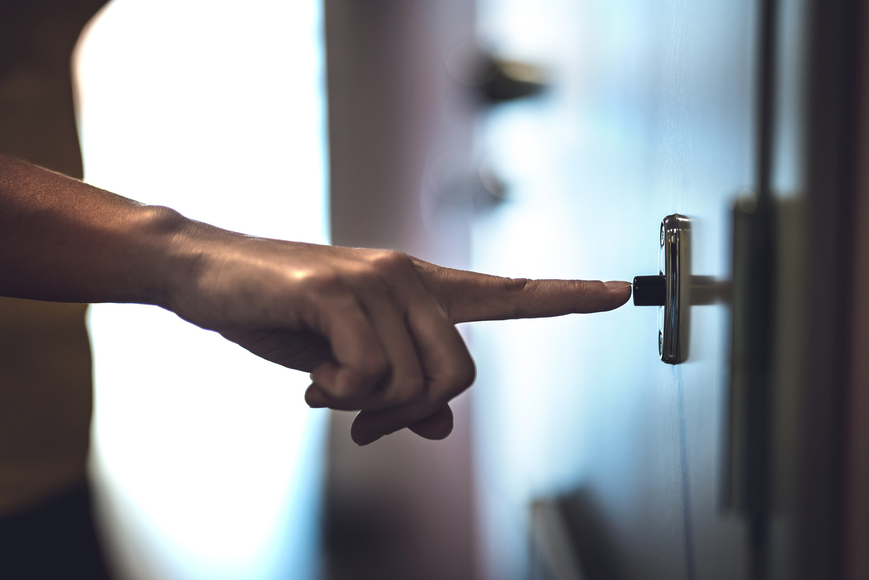 hand pressing doorbell