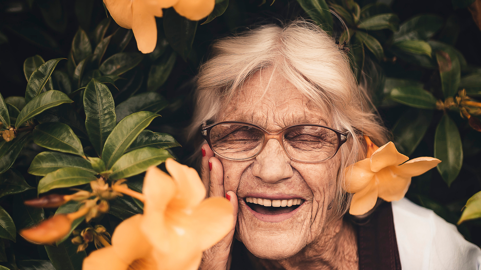 Elderly lady smiling in flowers Elderly lady smiling in flowers