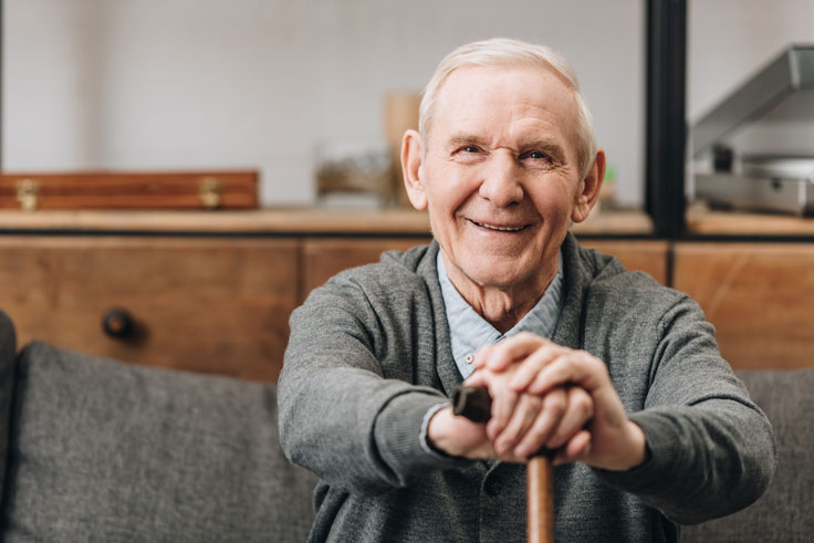 Older-man-sat-with-walking-stick Older-man-sat-with-walking-stick