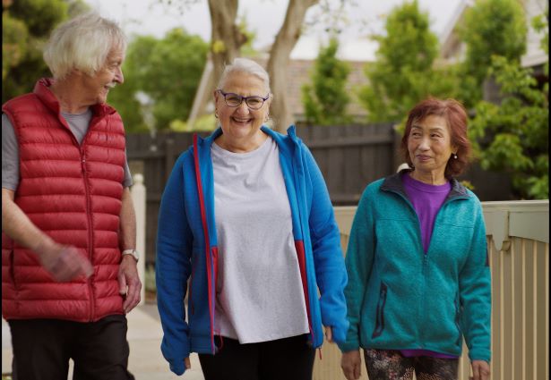 3 older people walking along the street