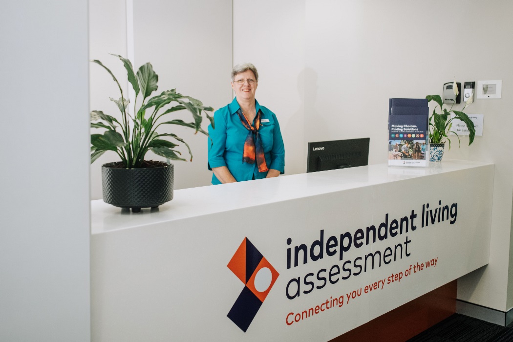Female in ILA uniform at front reception professional female standing in ILA reception area