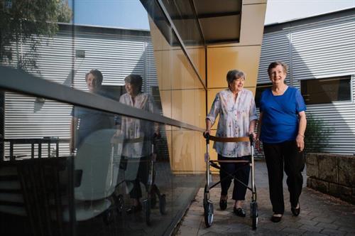 Allied health_Community_Physiotherapy Female Indigo staff assisting older female exercising in lounge room