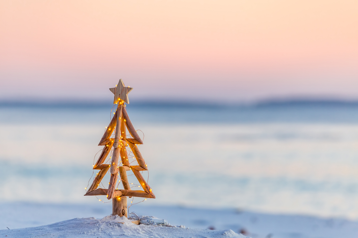 blurred image of a beach sunset with metal Christmas in foreground